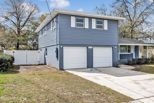 8194 Caravelle Dr, Jacksonville, FL 32244 - view of front of property featuring brick siding, a gate, fence, a garage, and driveway