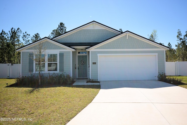 view of front of property with a garage, driveway, a front lawn, and fence