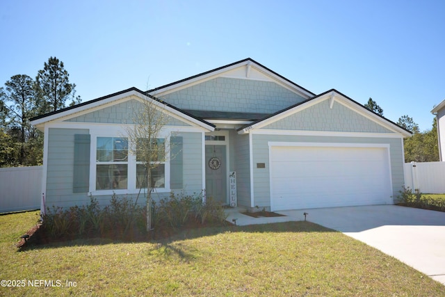 view of front of house featuring a garage, a front yard, fence, and driveway