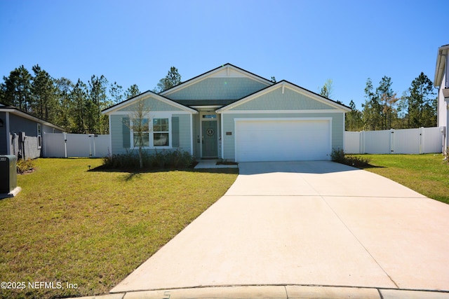 view of front facade with driveway, a front yard, and a gate