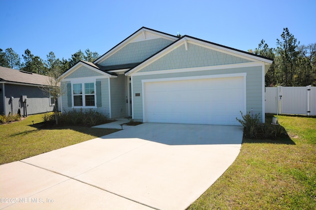 view of front of property featuring a garage, fence, concrete driveway, a gate, and a front yard