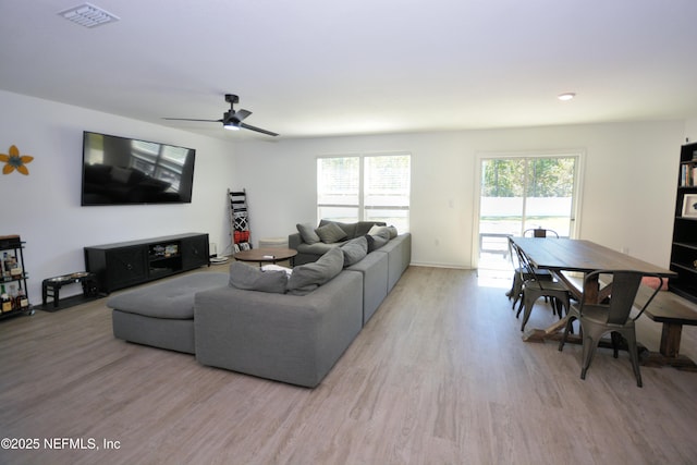 living area featuring visible vents, ceiling fan, and wood finished floors