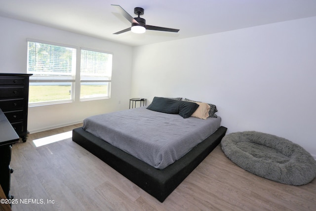 bedroom with wood finished floors and a ceiling fan