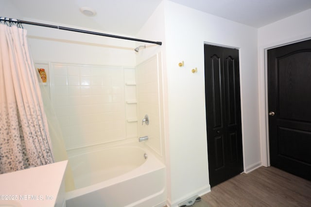 full bath featuring shower / bathtub combination with curtain, baseboards, and wood finished floors