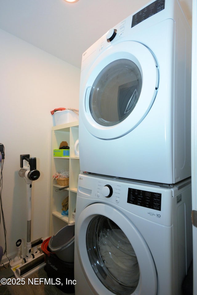 laundry room featuring stacked washing maching and dryer and laundry area