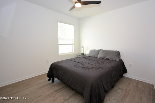 bedroom featuring baseboards, a ceiling fan, and light wood-style floors