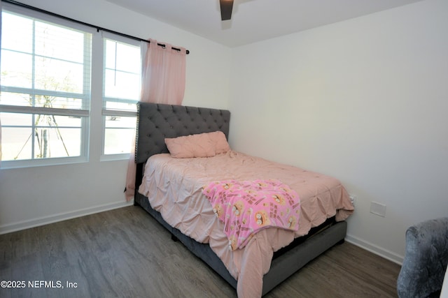 bedroom with wood finished floors, a ceiling fan, and baseboards