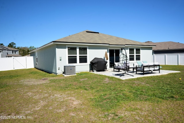 back of house featuring a yard, a patio area, a fenced backyard, and cooling unit