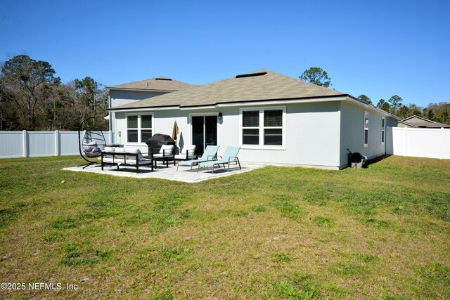 back of house with a patio area, a lawn, a fenced backyard, and stucco siding