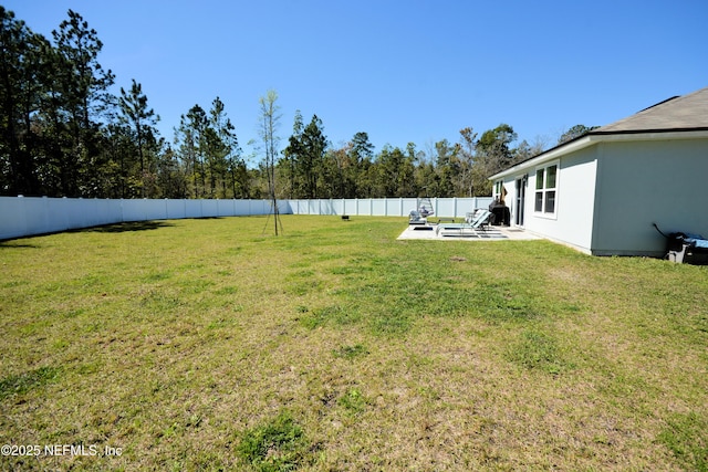 view of yard featuring a patio area and a fenced backyard