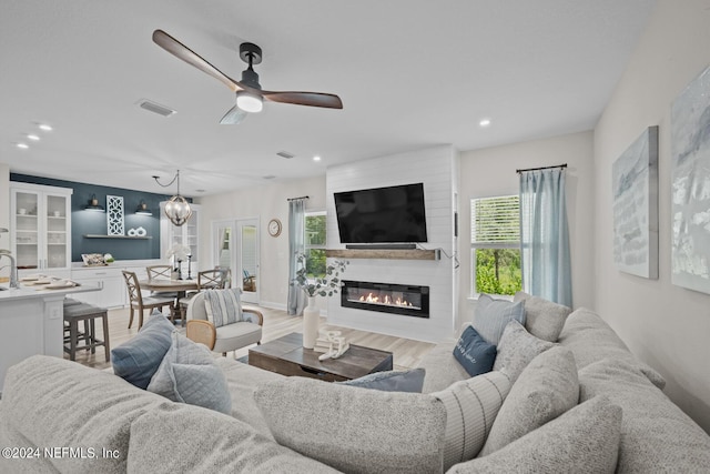 living area featuring ceiling fan, recessed lighting, a large fireplace, wood finished floors, and visible vents