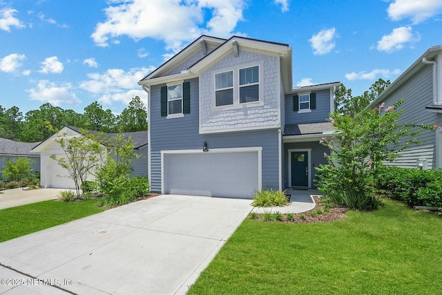 view of front of home with an attached garage, concrete driveway, and a front yard