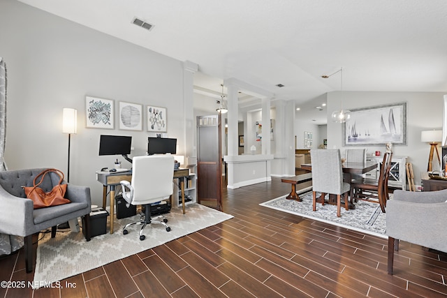 office with lofted ceiling, visible vents, and wood finish floors