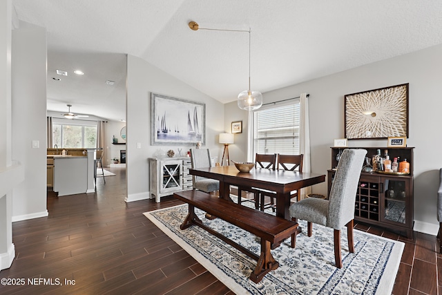 dining area featuring wood finish floors, visible vents, vaulted ceiling, and baseboards