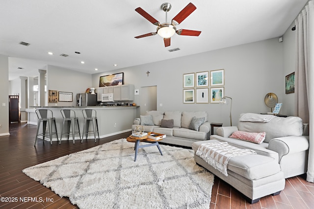 living area featuring dark wood-style floors, ceiling fan, baseboards, and recessed lighting