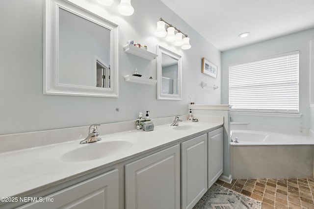 bathroom featuring a bath, double vanity, a sink, and recessed lighting