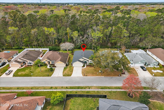 aerial view with a residential view and a wooded view