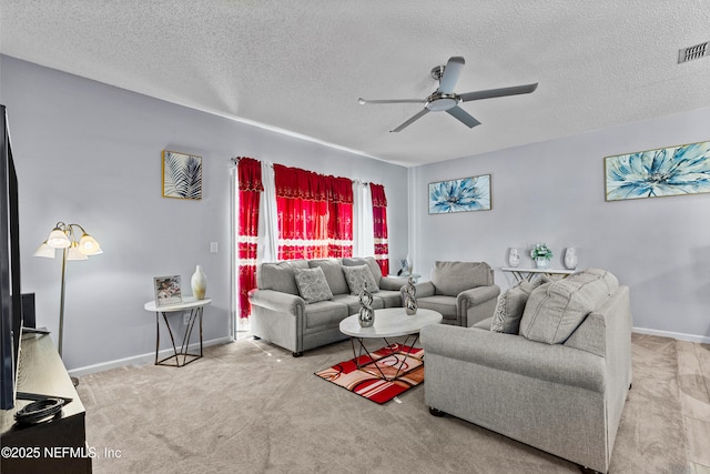 carpeted living area featuring ceiling fan, a textured ceiling, visible vents, and baseboards