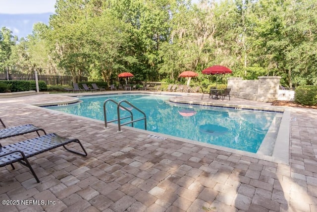 pool featuring a patio and fence