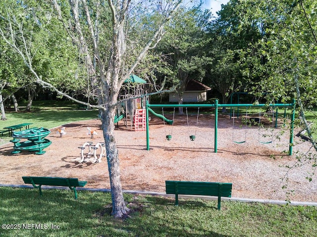 view of home's community featuring playground community and a yard