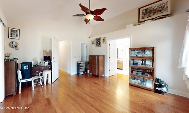 office with high vaulted ceiling, ceiling fan, baseboards, and wood finished floors