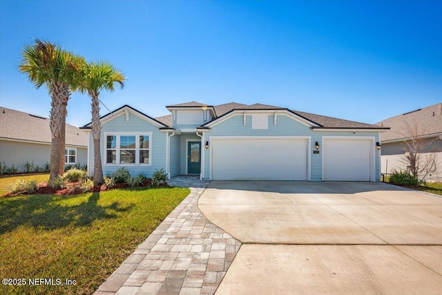 view of front facade with a front lawn, an attached garage, and driveway