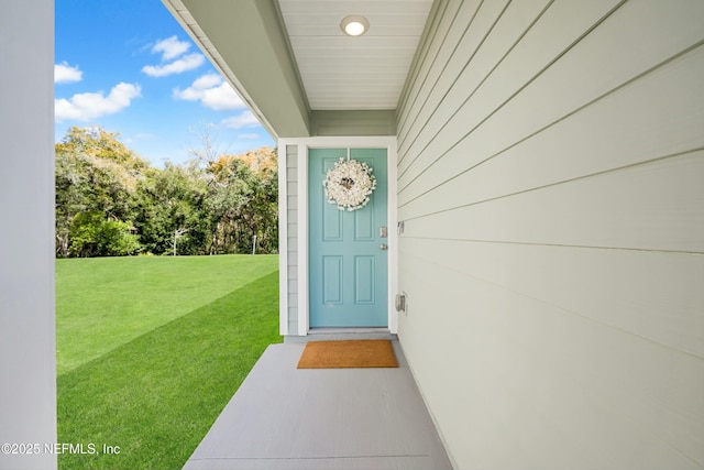 entrance to property featuring a yard