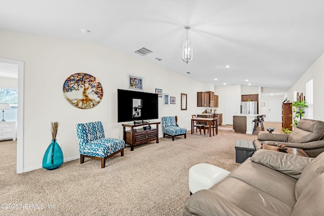 living area with light carpet, lofted ceiling, visible vents, and recessed lighting