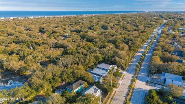 aerial view with a water view and a forest view