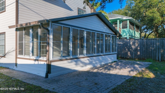 exterior space with a sunroom and fence