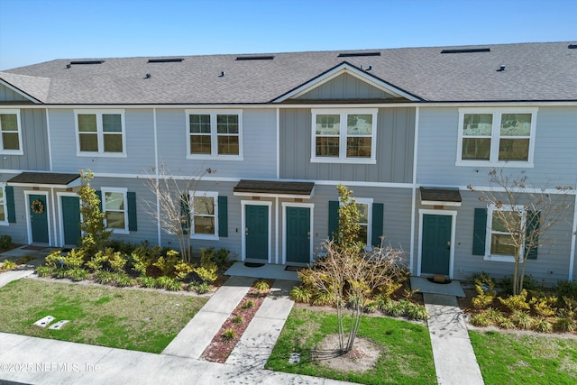 multi unit property with a shingled roof and board and batten siding