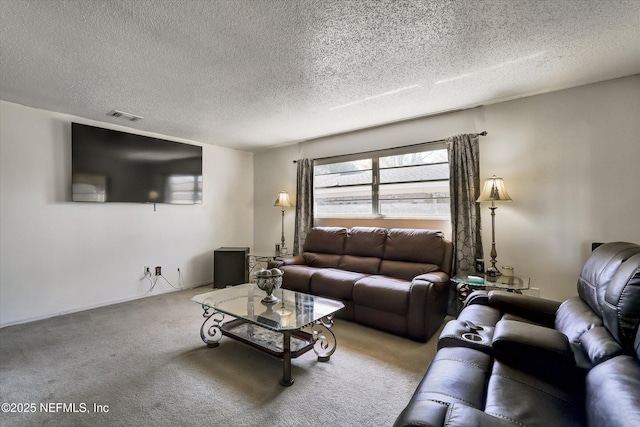 living area with visible vents, carpet flooring, and a textured ceiling