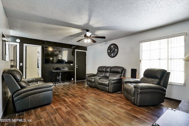 living area featuring ceiling fan, baseboards, a textured ceiling, and wood finished floors