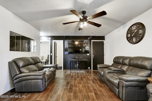 living area featuring ceiling fan, wood finished floors, and a textured ceiling