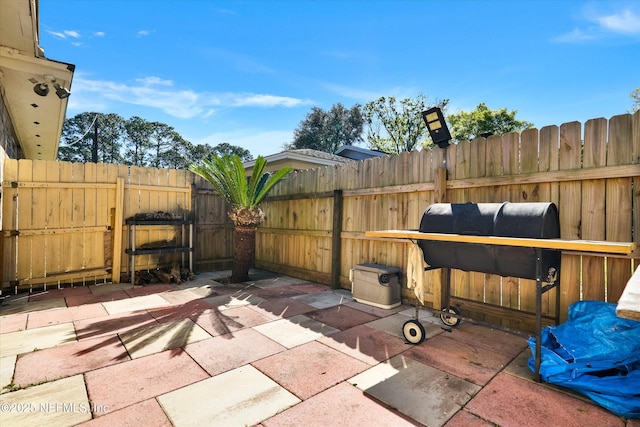 view of patio / terrace featuring fence and a grill