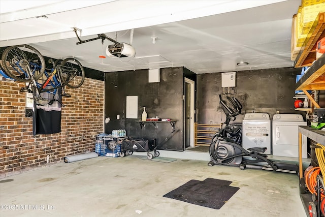 garage with a garage door opener and washing machine and dryer