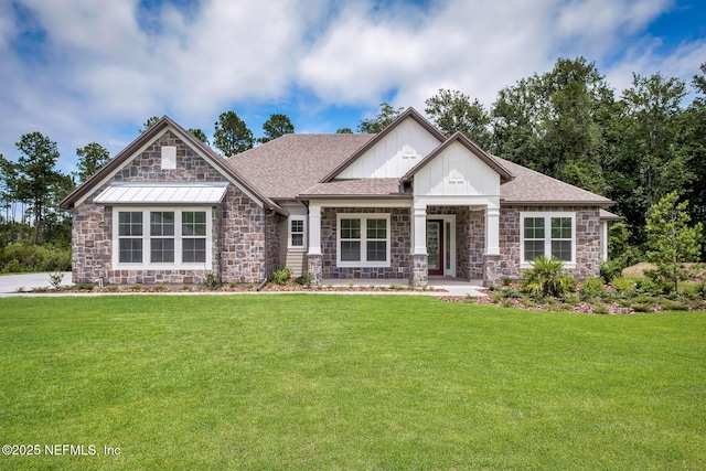 craftsman-style house featuring a shingled roof, a front yard, stone siding, and board and batten siding