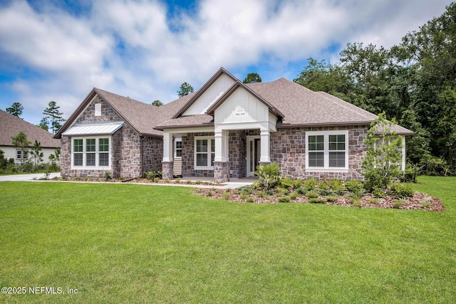 craftsman-style home with stone siding, roof with shingles, and a front lawn