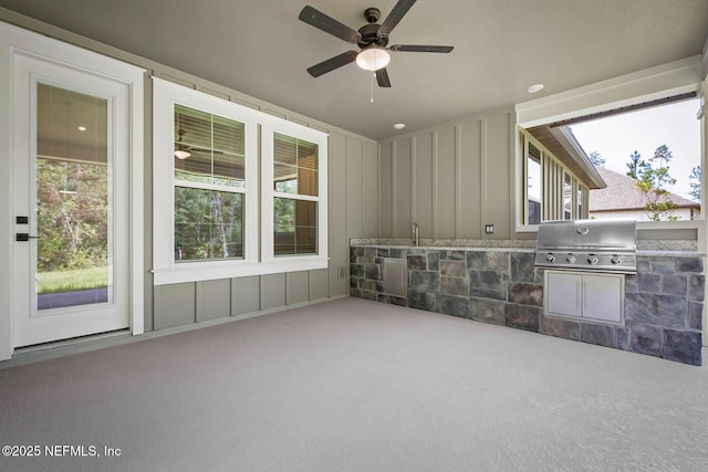 view of patio / terrace with a ceiling fan, exterior kitchen, and area for grilling