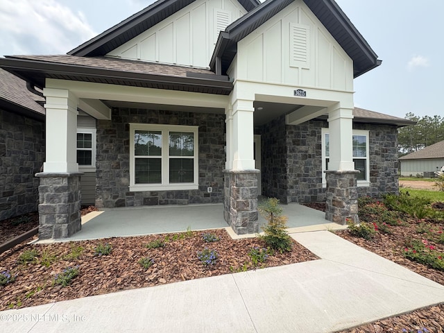 36215 Pitch Ln, Hilliard, FL 32046 - entrance to property featuring board and batten siding, covered porch, stone siding, and a shingled roof