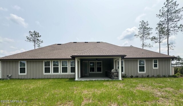 36215 Pitch Ln, Hilliard, FL 32046 - back of house with board and batten siding, a patio, and a lawn