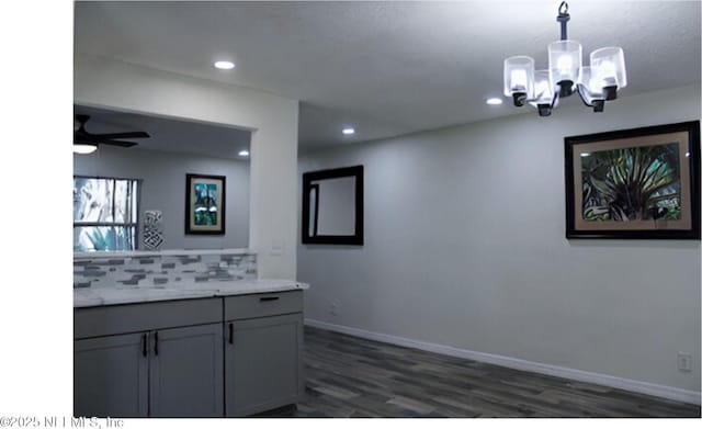 kitchen featuring recessed lighting, ceiling fan with notable chandelier, dark wood-type flooring, baseboards, and decorative backsplash