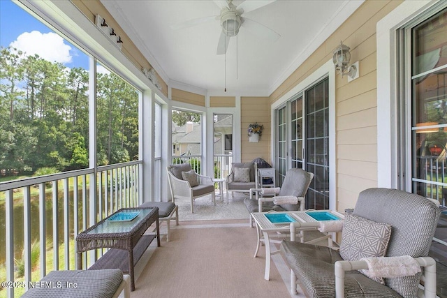 sunroom featuring ceiling fan