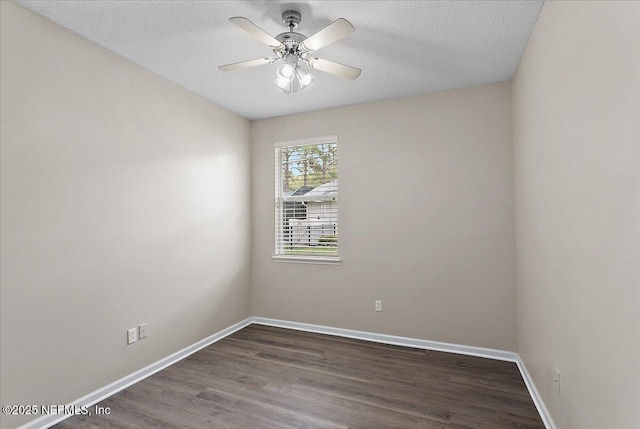 spare room with ceiling fan, a textured ceiling, baseboards, and wood finished floors