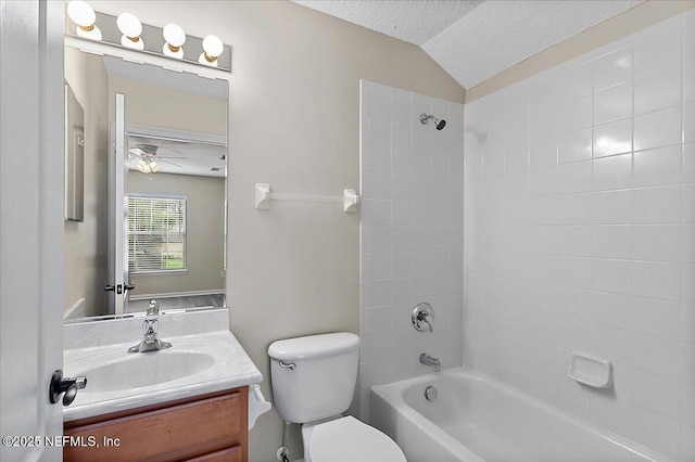 bathroom with toilet, lofted ceiling, a textured ceiling, vanity, and washtub / shower combination