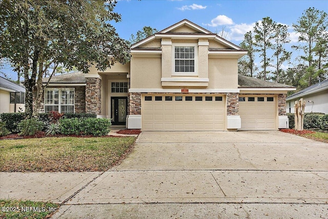 traditional-style home featuring driveway, stone siding, and stucco siding