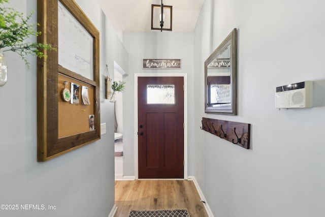 entryway with baseboards and wood finished floors