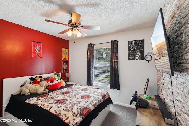 bedroom with ceiling fan, carpet, and a textured ceiling