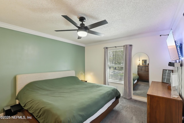 carpeted bedroom with a textured ceiling, ceiling fan, and crown molding