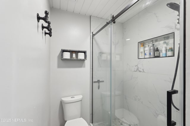 full bath featuring a marble finish shower and toilet